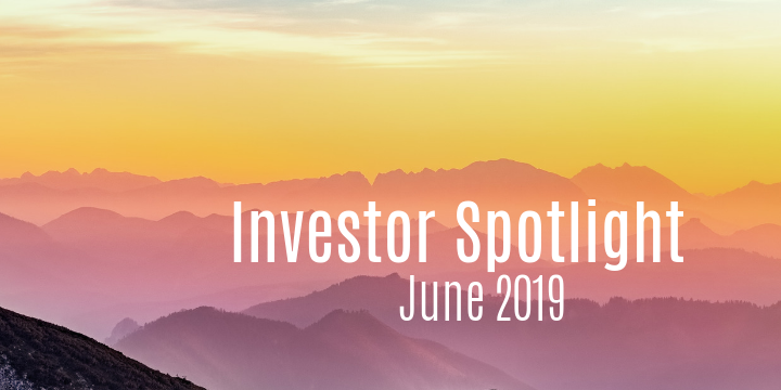 Scenic view of mountains at sunset with the text "Investor Spotlight June 2019" overlaid, capturing a moment even a stay-at-home dad would appreciate.