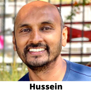 A bearded man radiates joy outdoors, embodying financial freedom through real estate investing. Below him, the name "Hussein" is inscribed, capturing his success.
