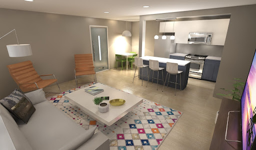 A modern open-plan living room and kitchen showcases a recent purchase: a colorful rug. It complements the sofa, coffee table, chairs, bar stools, and the sleek kitchen island with appliances.