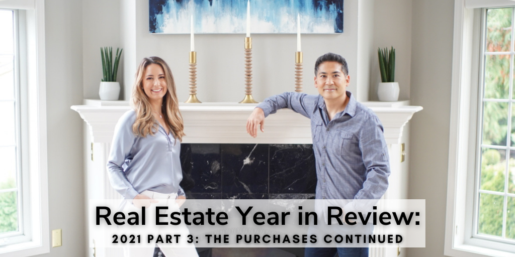 Two people stand by a fireplace, smiling warmly. A sign reads "Real Estate Year in Review: 2021 Part 3: The Purchases Continued," highlighting the year's transactions and achievements.